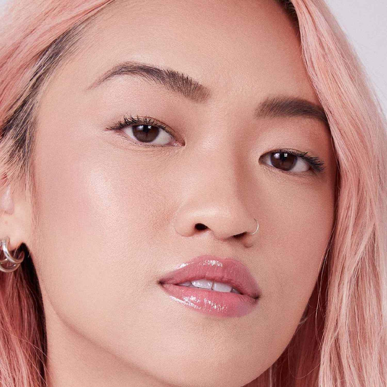 Woman with pink hair and dewy makeup look