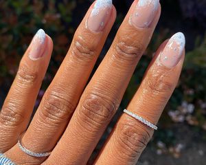 A snowy, glittery French manicure