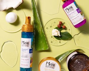 four maui moisture products on a green backdrop with pieces of aloe