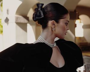 Selena Gomez wears a low bun with ribbon