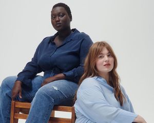 Women wearing blue button-down blouses and jeans on a white background