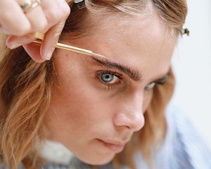 woman trimming eyebrows