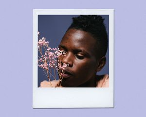 man smelling flowers