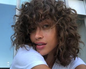 A close up of the model Alanna Arrington with her naturally curly hair