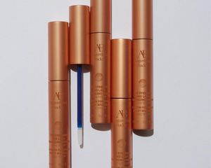 Augustinus Bader The Eyebrow and Lash Serum bottles on a grey background