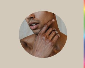 Man with his hands near his face.