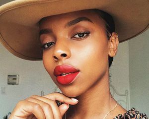 Black woman in a camel hat and red lipstick