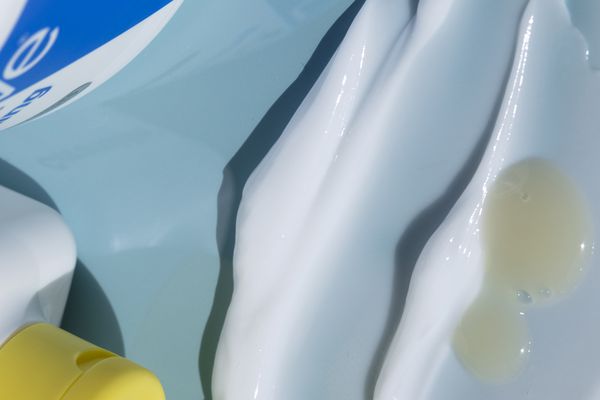 Swatches of hydrating skincare products on a blue background