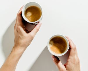 Cups of coffee on a white background