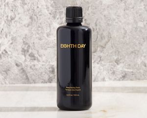 Eighth Day Resurfacing Tonic on a marble background 