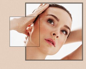 woman with hand on hairline and glitter on face