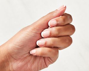 Close up of a woman's hand with a French manicure