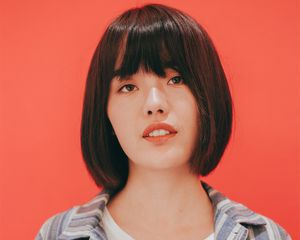 young woman in studio portrait on coral