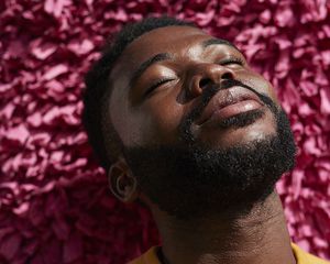 Man with a beard bathes his face in the sun