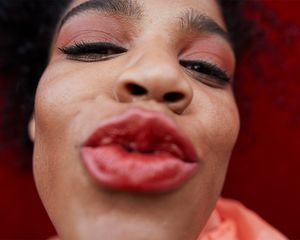 person making kiss face at camera