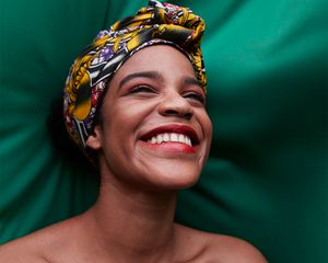 portrait of smiling person on green cloth