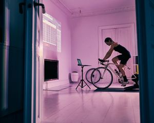 Woman on stationary bike in her living room