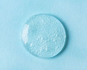 drop of clear gel on blue background