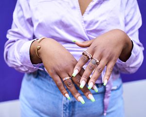 Close up of a woman's hands with acrylic nails.