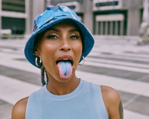Woman with blue tongue and tongue piercing