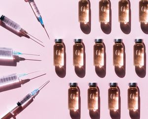 Bottles of neuromodulators surrounded by syringes