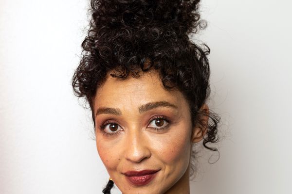 Ruth Negga wears a curly updo with baby bangs