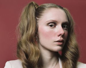 Woman with rosy red cheeks.