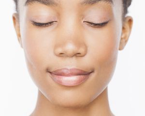 Woman with clear skin with eyes closed