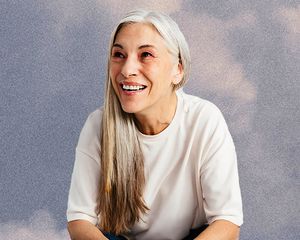 woman with gray hair on cloudy sky background