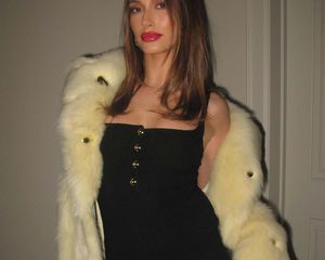 Hailey Bieber in a balck dress and fur coat