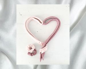 Pink heatless hair curling ribbons arranged in a heart shape
