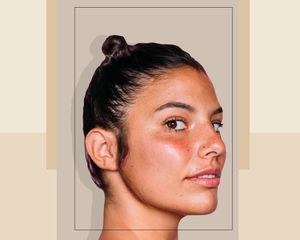 A Woman Looking at the Camera Wearing a Tight Topknot Bun on a Designed Background