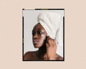 woman applying skincare to cheeks