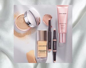 Laura Mercier products flat layed on a white background