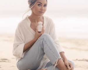 lauren conrad poses with her new fragrance loved