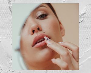 Woman applying lip balm