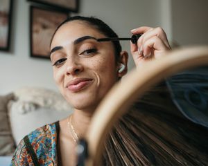 Woman applying mascara