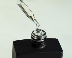 dropper of serum on a mint background