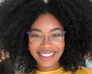 woman smiling posing with curly wash and go hair
