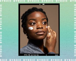 woman applying cream to cheeks