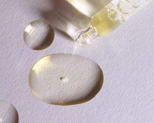 Drops of minoxidil on a white background