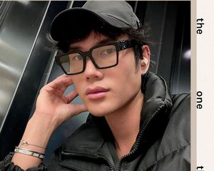 Close up of the makeup artist Patrick Ta in a black jacket