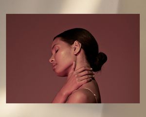 woman with smooth skin and hand on neck