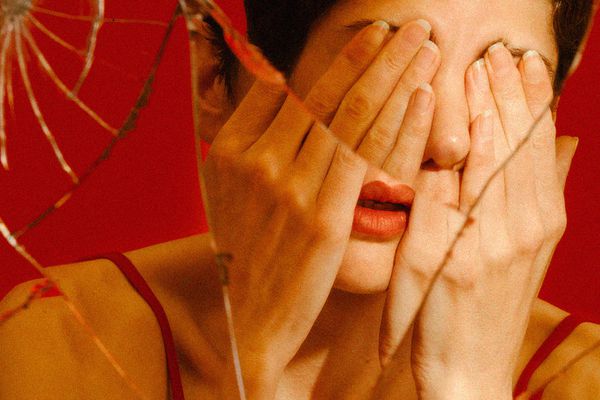 women with hand over eyes