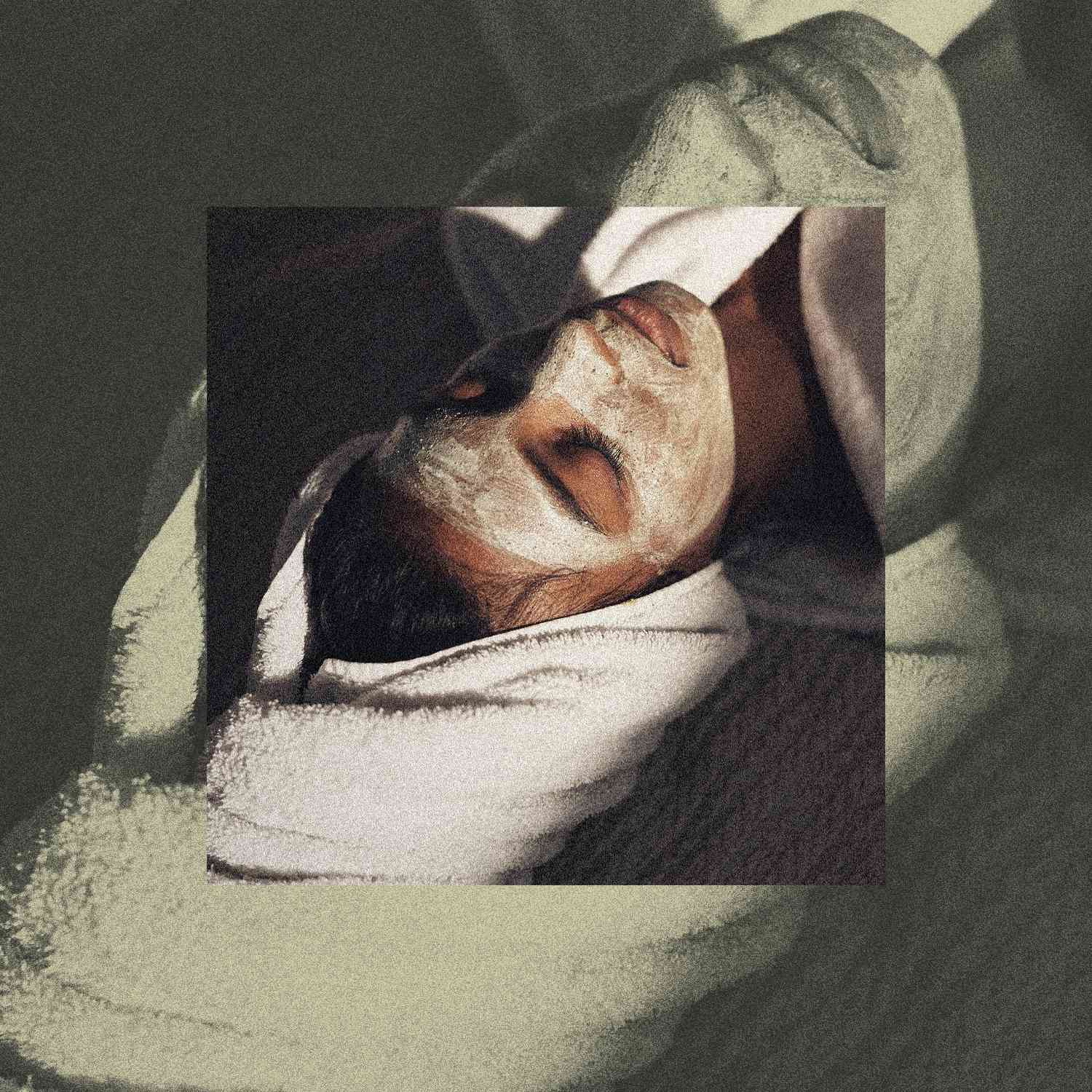 Woman in a skincare face mask with towel on her head