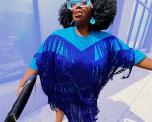 Model wearing blue fringe dress