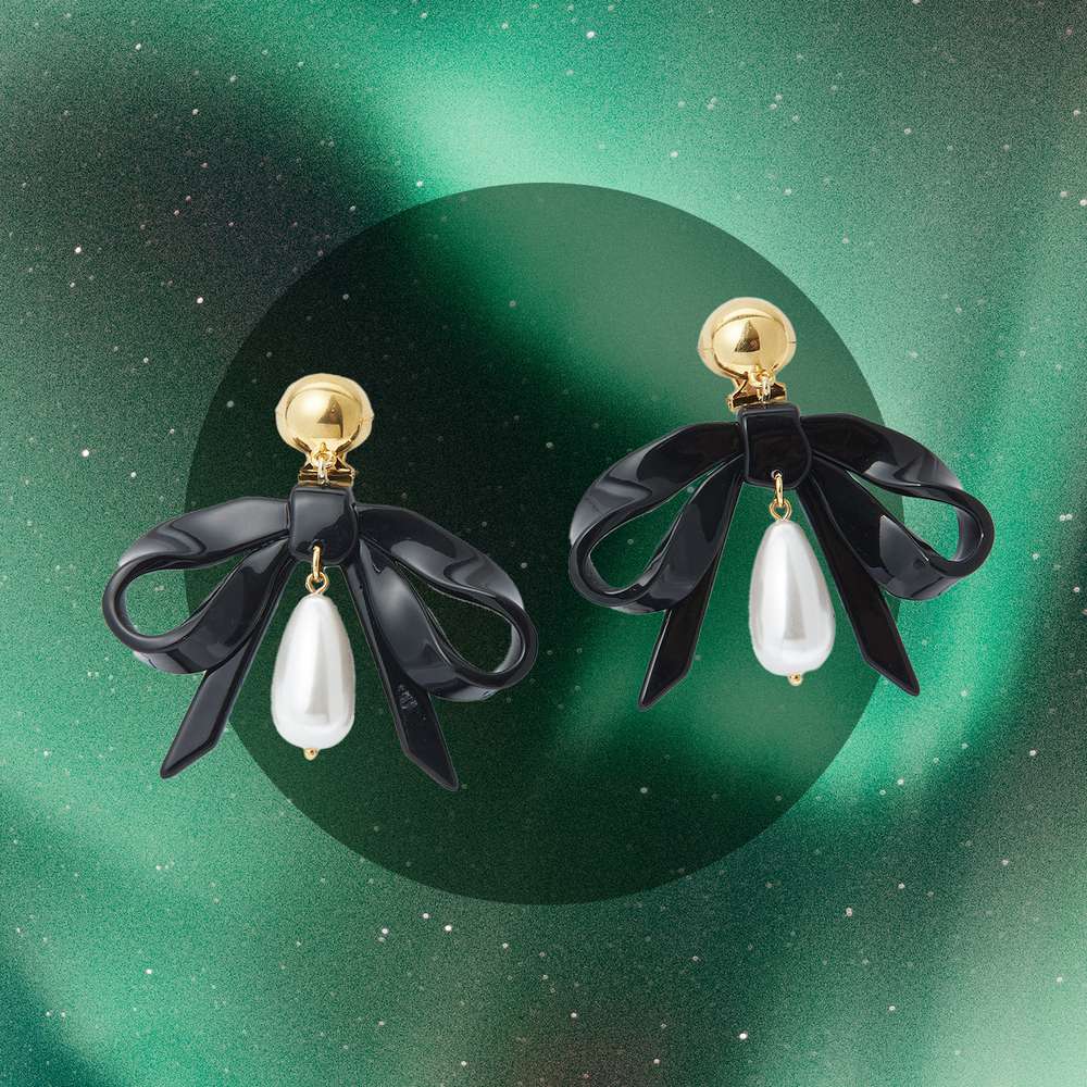 Lele Sadoughi pearl bow earrings.
