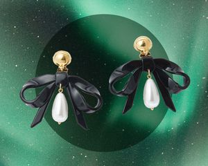 Lele Sadoughi pearl bow earrings.