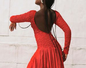 Model wearing a red Mara Hoffman dress
