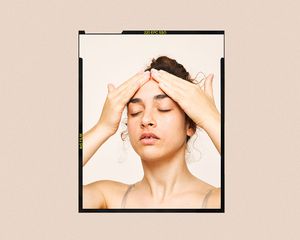 woman with hands on forehead